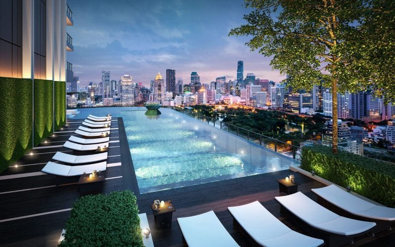 Un logement ultra moderne avec piscine à Bangkok, de nuit. 